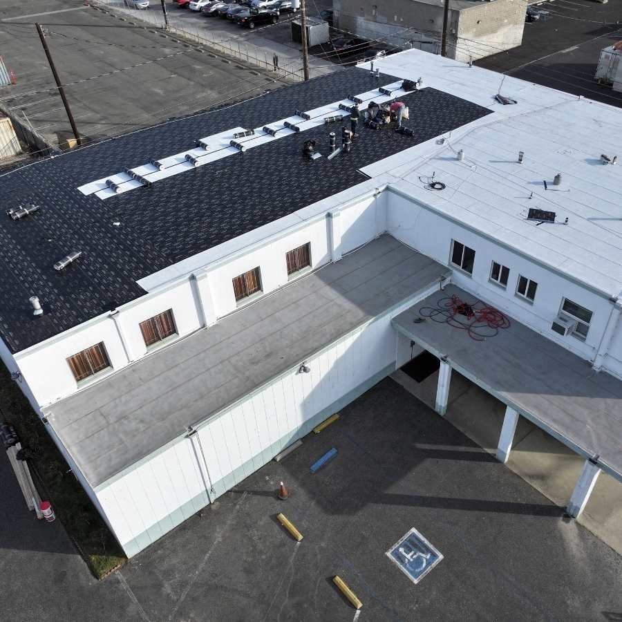 Los Angeles roofing project featuring a commercial flat roof installation in progress on a large industrial building.